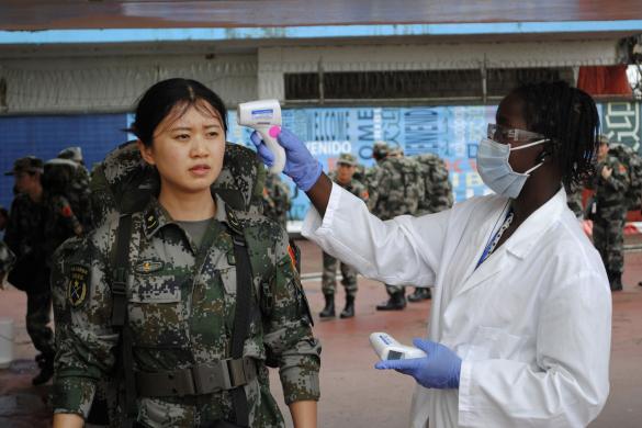 A Chinese military health worker has her temperature taken as she arrives at Roberts airport outside Monrovia, to help in the fight against Ebola