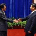 Japan’s Prime Minister Shinzo Abe shakes hands with China’s President Xi Jinping during their meeting on the sidelines of the APEC meetings in Beijing